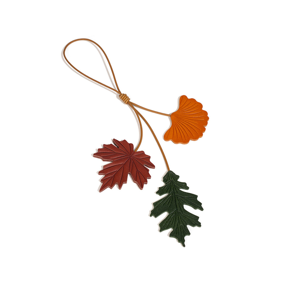 Decorative leaf leather charm with red, green, and orange leaves on a white background