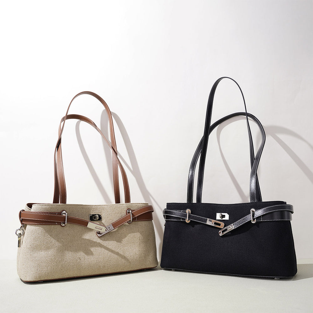 Two vegetable tanned leather bags, one beige and one black, on a light background
