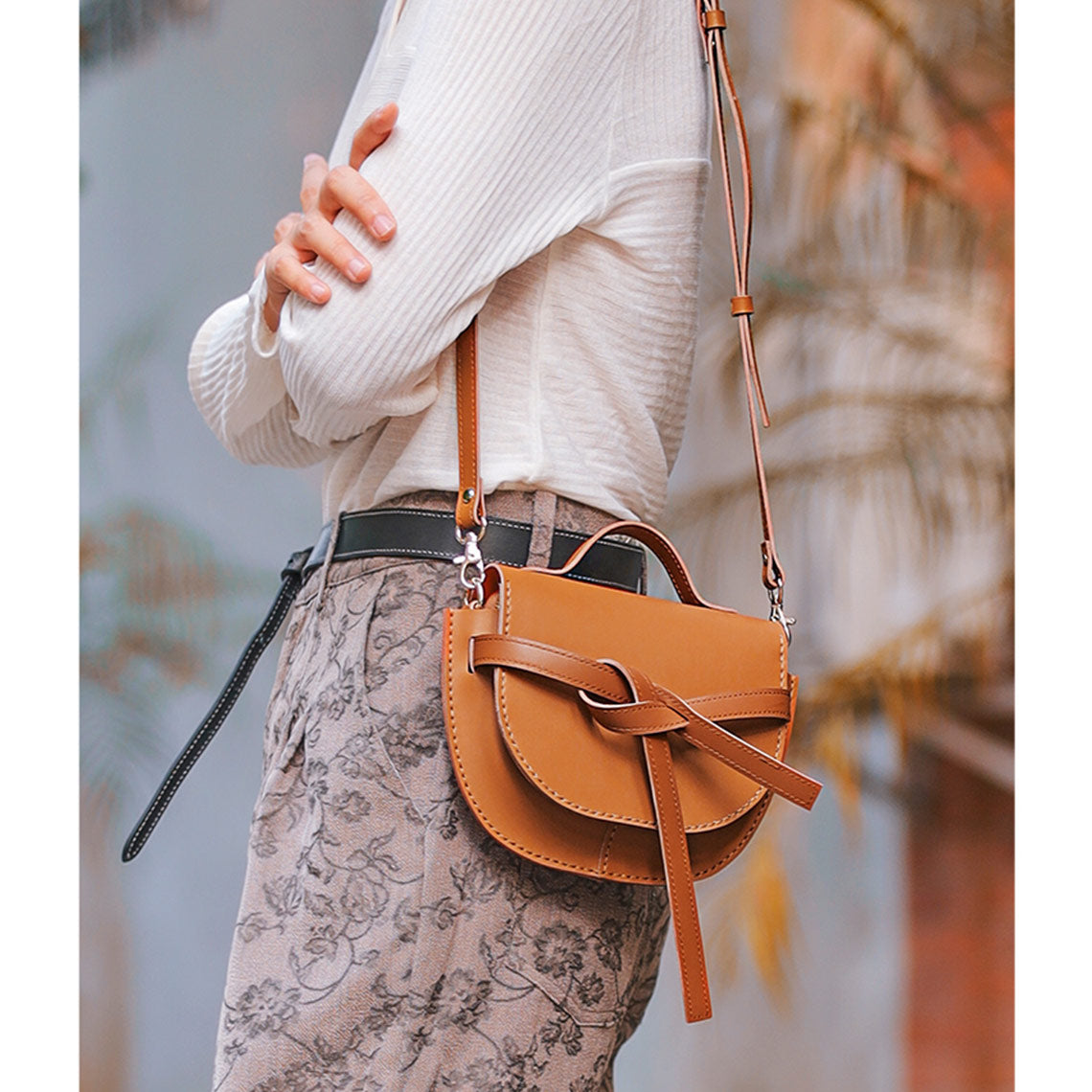 brown leather saddle bag  wearing by a young lady   | POPSEWING